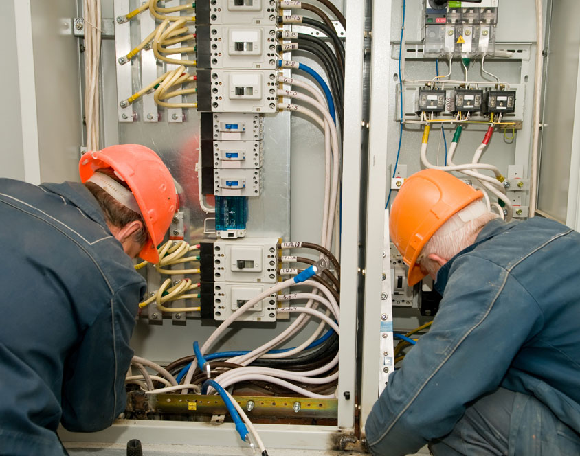 Two electricians checking the wirings