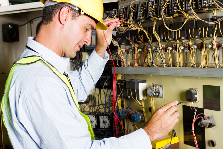 Electrician checking the electrical flow using the tester